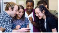 Happy students looking at phone screen